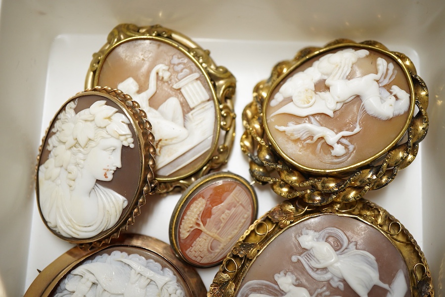 Six assorted Victorian and later yellow or white metal mounted oval cameo shells, one frame stamped 9ct, largest 64mm.